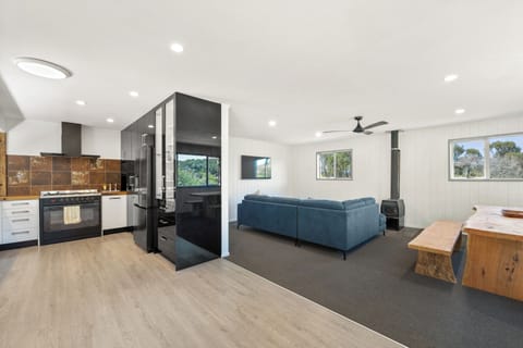 Open-plan kitchen/dining/living area with woodburner for winter