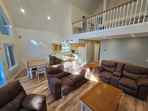 Looking from living room toward the dining room, kitchen and loft