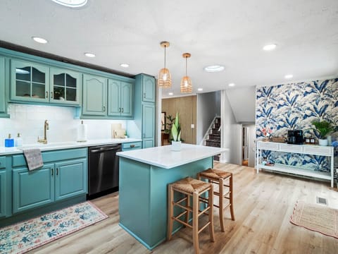 Coastal charm meets modern convenience 🌿🍽️ This fully equipped kitchen features teal cabinetry, quartz countertops, and a spacious island—perfect for cooking, gathering, or just sipping coffee in style.