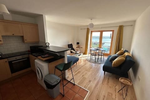 Fully fitted kitchen with breakfast bar, high chair and washer-dryer. 
