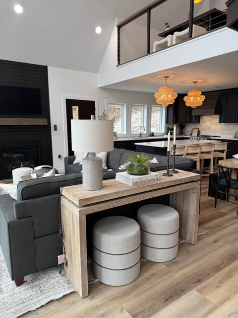 Family room with cozy one-switch fireplace next to the kitchen and dining
