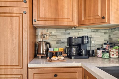 The kitchen is equipped with a Keurig K-Duo Essentials coffee maker, perfect for a quick cup of coffee or a full pot to start your day.