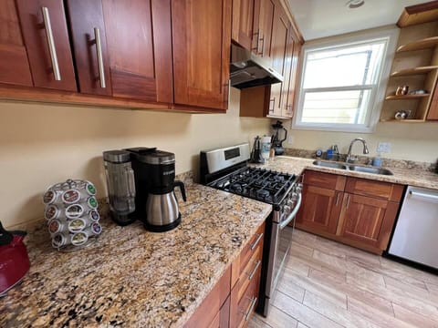Kitchen features a stove/oven, large sink, refrigerator, and other appliances.