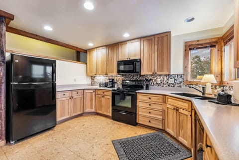 Kitchen: Drip coffee maker, Crockpot, toaster, cooking utensils, tableware