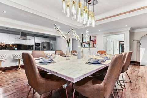 Modern luxury living and dining spaces with stunning city and waterfront views.