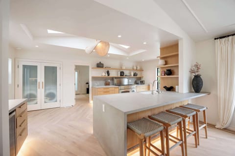 The sleek kitchen island glows with understated elegance, perfect for every occasion.