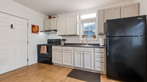 Kitchen with full size oven/stove and refrigerator.