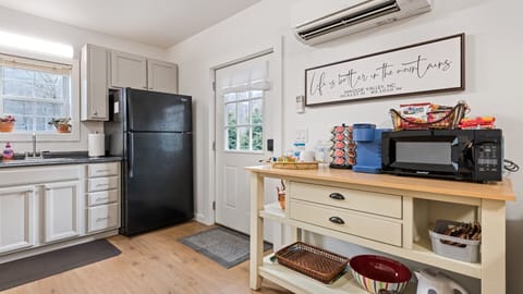Coffee bar with Keurig, French press, microwave, electric kettle, & rice cooker.
