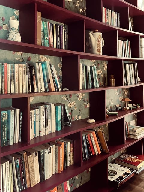 The bookcase is packed with novels to read while enjoying the sea view.