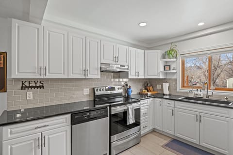Kitchen with dishwasher, oven, and stove