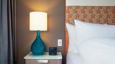 Unwind under warm lamplight beside crisp, cloud-soft linens.