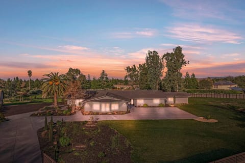 Experience serene living at sunset! This stunning ranch-style home offers spacious elegance, lush landscaping, and breathtaking views—perfect for peaceful evenings.
