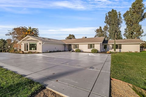 Modern elegance meets spacious living! Explore this stunning single-story home with a sleek concrete driveway, lush landscaping, and timeless charm. Your dream home awaits!