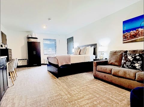 Unwind in this stylish, spacious retreat featuring a plush bed, cozy sofa, and sleek modern touches. Enjoy vibrant decor, comfy seating, and natural light—perfect for relaxing after a day at Cedar Point or exploring Sandusky!