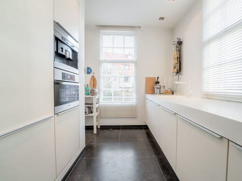 Flooring, Interior Design, Floor, Kitchen, Kitchen Appliance, Countertop, Cabinetry, Ceiling, Major Appliance, Lighting