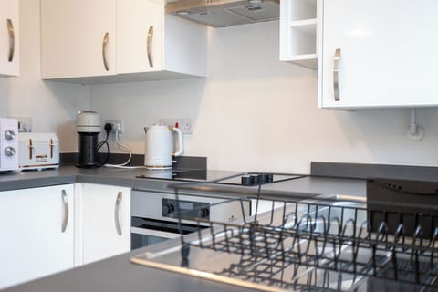 Kitchen sink, kettle, stove, oven, coffee machine, toaster available.