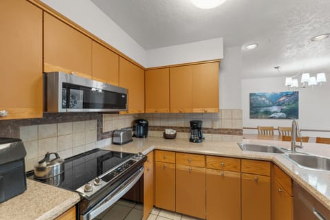 Full kitchen with stainless steel appliances and breakfast bar for casual dining.