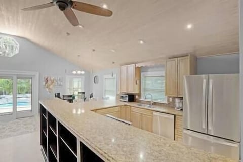 Kitchen leading to back outdoor pool area