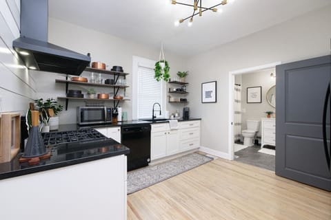 This kitchen is a feast for the eyes!  The warm wood floors and hanging greenery create a welcoming atmosphere.