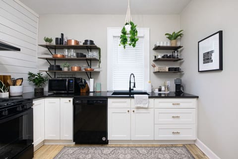 Black appliances, white cabinets, and a touch of rustic charm. This kitchen is a total win!