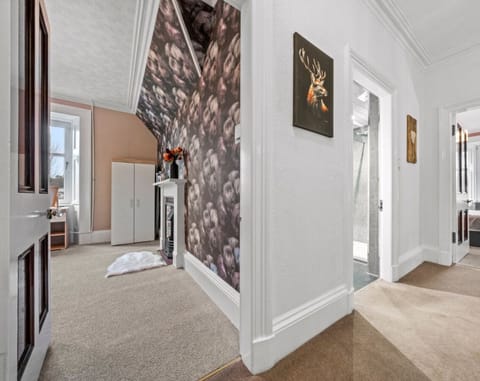Charming Upstairs Retreat: A sweeping view of the upstairs bedrooms and bathroom, where comfort meets style in a beautifully coordinated space