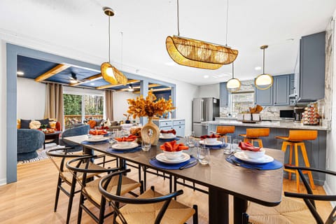 Bright and modern dining and living area with stylish decor, a spacious 8 seater dining table setup, and an open-concept kitchen perfect for gatherings.