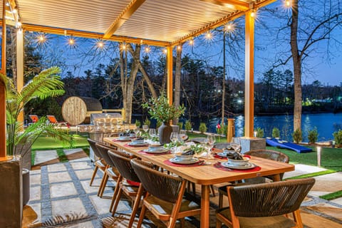 Bring the indoors out with this outdoor dining area featuring a TV and BBQ Grill.