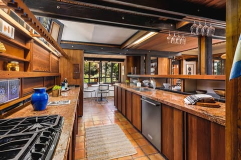 Cook in rustic elegance! This gourmet kitchen features rich wood cabinetry, granite countertops, and an open layout perfect for both everyday meals and entertaining.