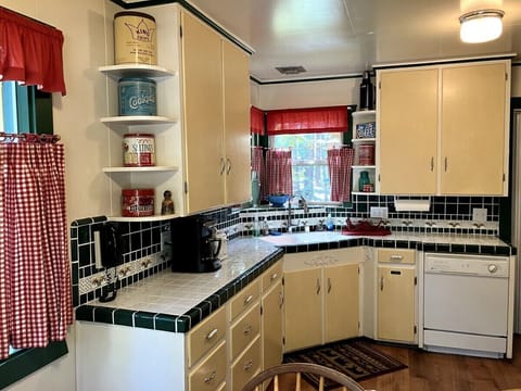 The large open kitchen has a gas stove, oven, microwave & dishwasher.