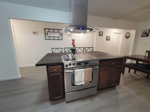 Center Island with fully equipped kitchen with air fryer microwave, coffee maker,  waffle maker and basic condiments.