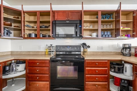 Enjoy crisp white finishes, abundant natural light, and plenty of warm wood cabinetry for storage.