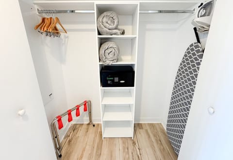Spacious walk-in closet with shelves and hangers for convenient storage.