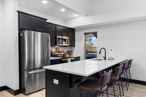 Full Kitchen with Stainless Steel Appliances and Additional Bar Seating