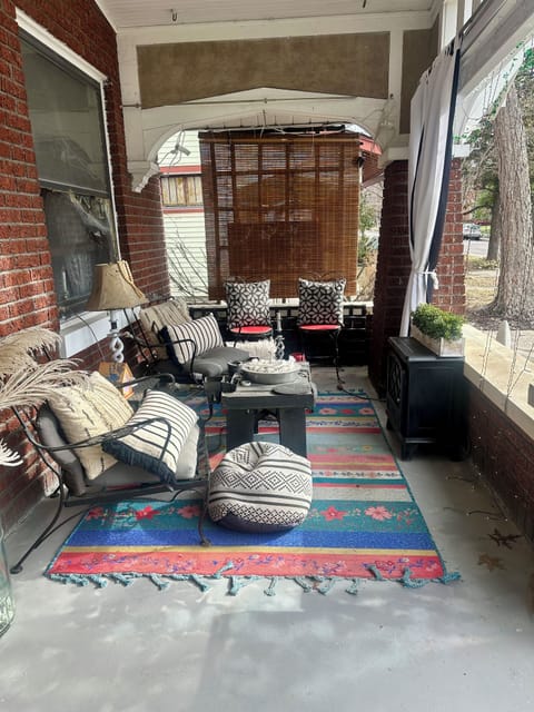 Front porch has electric fireplace, fan, and tv.
