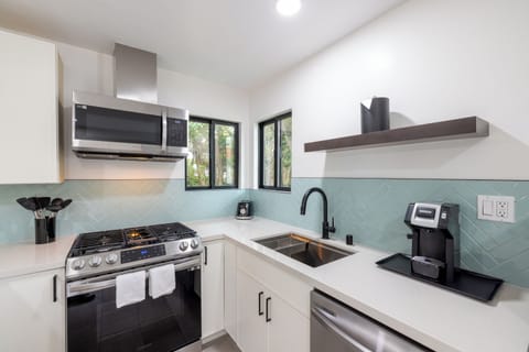 kitchen with stove, oven, sink, and coffee maker