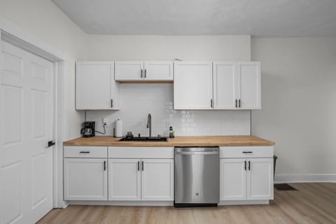 Kitchen: Sleek white cabinetry and butcher block counters make cooking a delight! Enjoy modern amenities!
