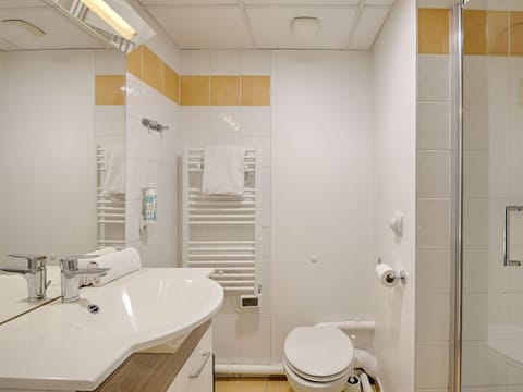 Contemporary bathroom with a sleek walk-in shower, heated towel rail, and bright, modern fixtures for a spa-like feel.