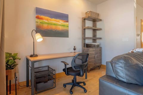 The dedicated workspace is conveniently located next to the living room.