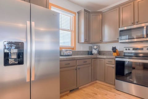 The kitchen features modern stainless steel appliances.