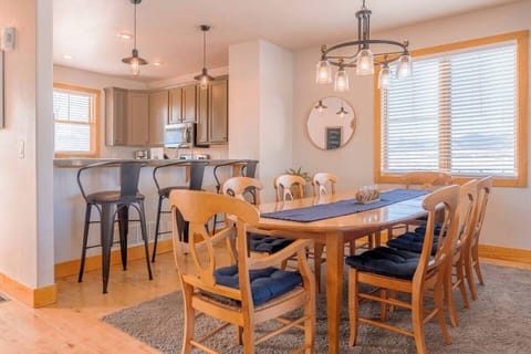 The dining area seats eight, with three more at the kitchen island—ideal for meals and gatherings.