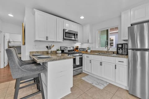 Fully stocked kitchen with blender, huge pots and coffee maker