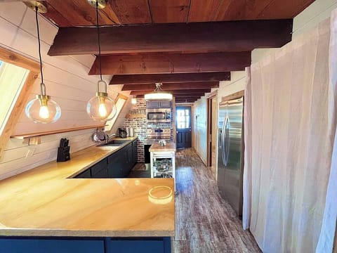 updated kitchen with new, stackable washer/dryer behind the curtain (1)