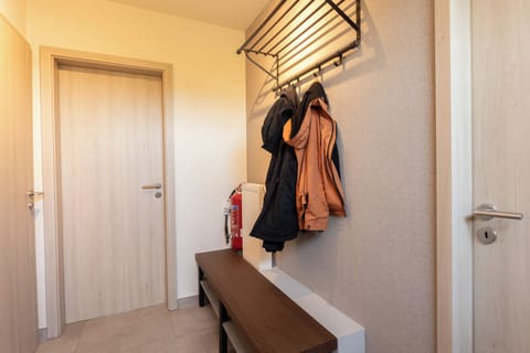 Hallway with room for boots and placing jackets.