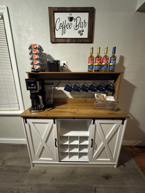 MAIN LEVEL, KITCHEN: Open floor concept flows from Living Room into the Kitchen with Deluxe Coffee Bar: Deluxe Dual Ninja Coffee maker with both single serve, K-cup coffee pods, or make a pot of your favorite grind, Special variety of coffee syrups, Manual Coffee Grinder, and a French Press for all the coffee connoisseurs. Selected variety of organic tea bags.