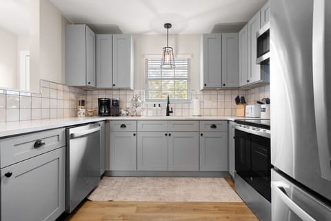 A kitchen that has it all -- coffee station, cookware, silverware, dinnerware.