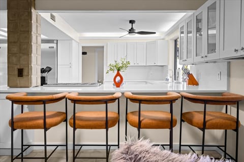 Gather around the large island with high seating—perfect for casual meals, drinks, or good conversation in a spacious and inviting kitchen!