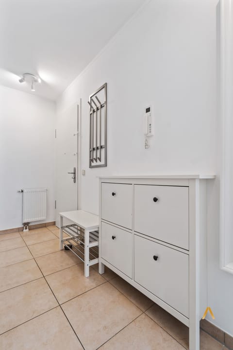 Welcoming entryway with convenient shoe storage and modern decor. A perfect spot to organize your belongings as you enter or leave the apartment.