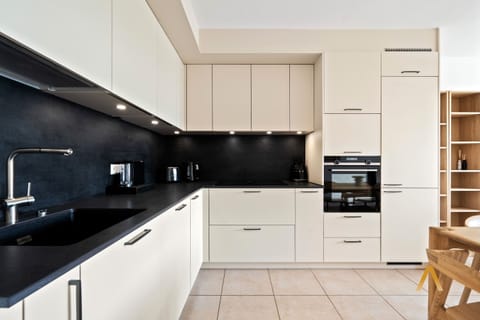 Sleek, contemporary kitchen with state-of-the-art appliances. Ideal for preparing gourmet meals. Plenty of counter space and storage for all your needs.