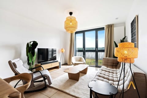 Bright and airy living room with large windows offering plenty of natural light. Comfortable seating and modern decor make this space perfect for relaxation.