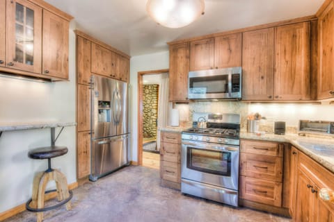 Full kitchen w/ modern appliances: toaster, crockpot, drip coffee maker, wine ware, spices, foil, and much more!